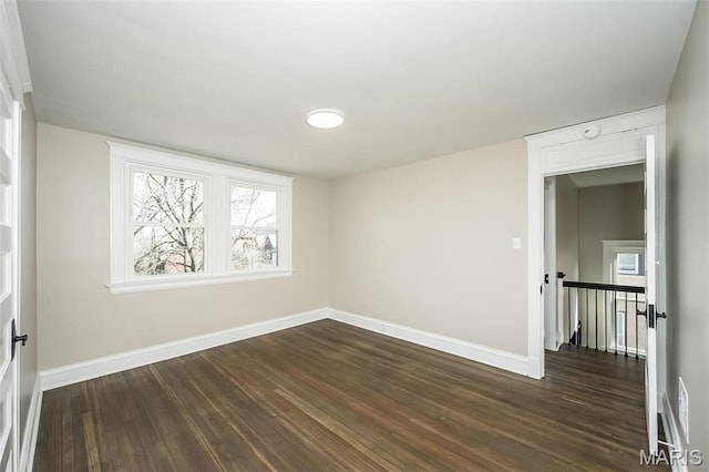 7642 Westmoreland Ave, Saint Louis, MO 63105 - empty room with baseboards, dark wood-style floors, and plenty of natural light