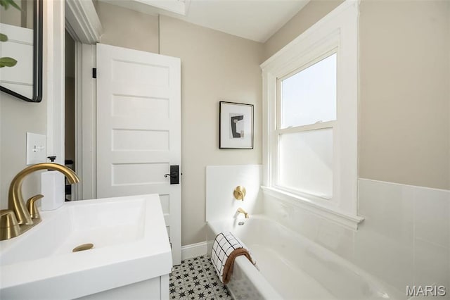 7642 Westmoreland Ave, Saint Louis, MO 63105 - full bath with a garden tub, baseboards, vanity, and tile patterned floors