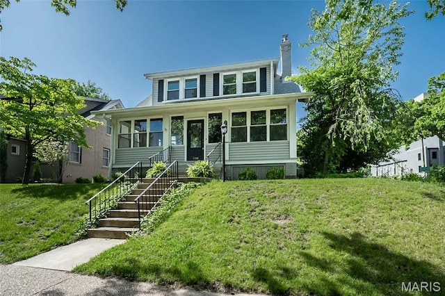 7642 Westmoreland Ave, Saint Louis, MO 63105 - view of front of house featuring a front lawn and a chimney