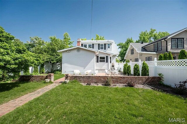 7642 Westmoreland Ave, Saint Louis, MO 63105 - back of property featuring a chimney and a patio area