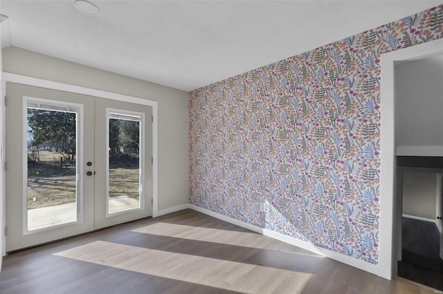 470 Saint Paul Dr, New Madrid, MO 63869 - unfurnished room featuring french doors, wood finished floors, wallpapered walls, and baseboards