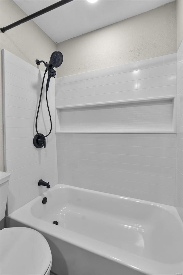 470 Saint Paul Dr, New Madrid, MO 63869 - bathroom featuring a textured wall, toilet, and tub / shower combination