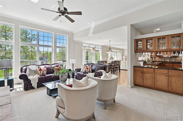 living room with light colored carpet, ornamental molding, a ceiling fan, and recessed lighting