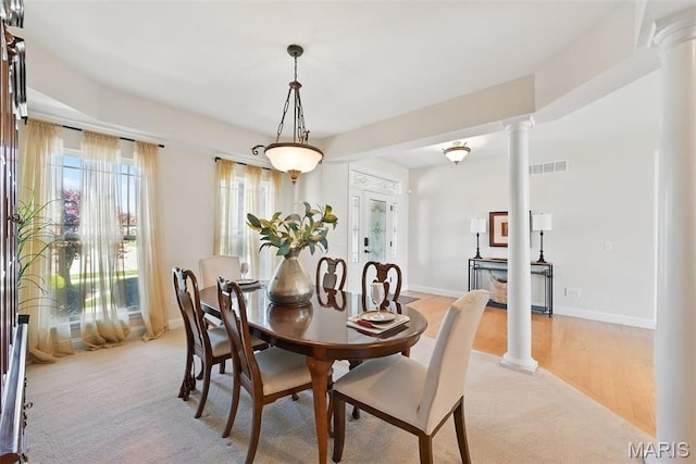 dining area with decorative columns and baseboards