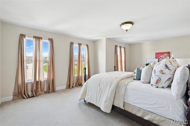 carpeted bedroom featuring baseboards
