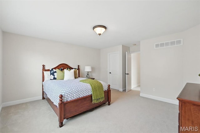 bedroom featuring light colored carpet and baseboards