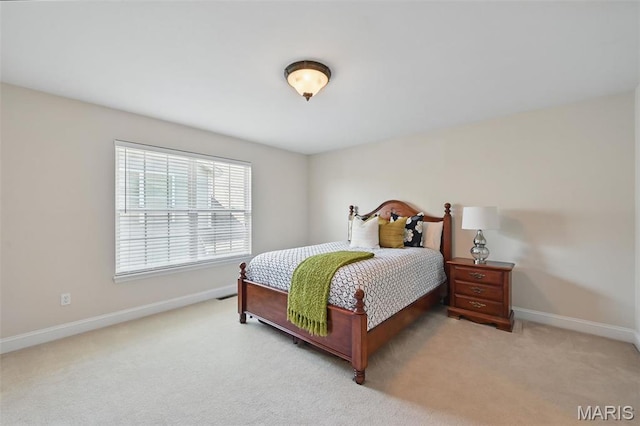 carpeted bedroom featuring baseboards