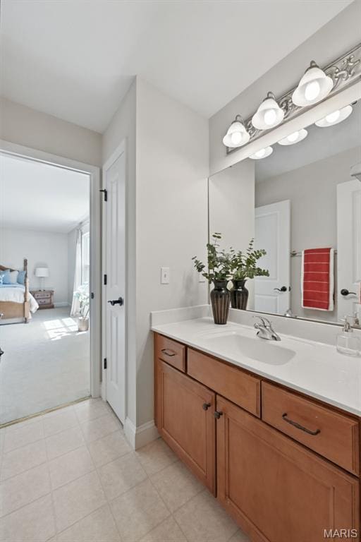 bathroom featuring vanity, baseboards, and tile patterned floors