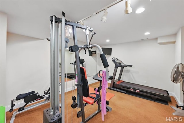 workout room featuring baseboards, recessed lighting, and track lighting