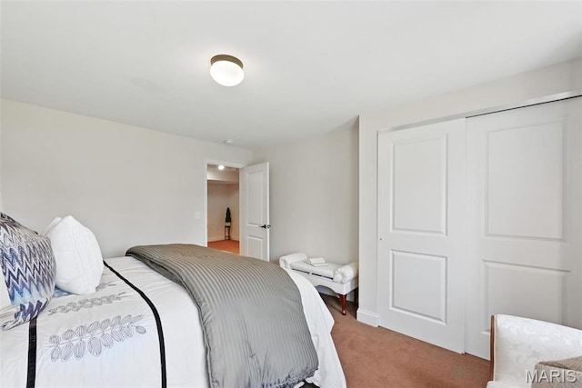 bedroom featuring light colored carpet and a closet