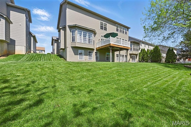 back of property with a lawn