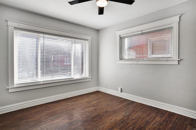 unfurnished room featuring baseboards, wood finished floors, ceiling fan, and a textured ceiling