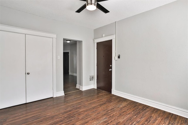 unfurnished bedroom with wood finished floors, baseboards, a closet, and ceiling fan