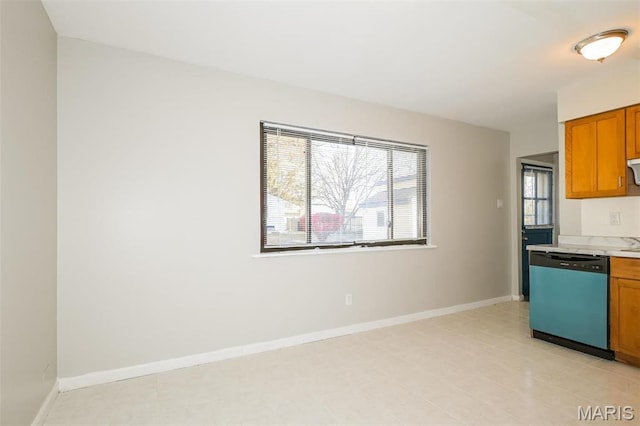 1235 Flicker Dr, Florissant, MO 63031 - kitchen with dishwasher, light countertops, and brown cabinetry