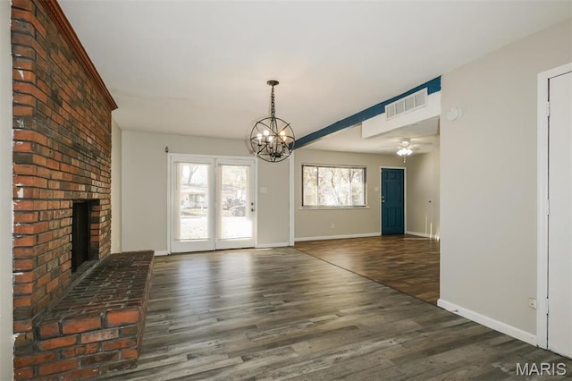 1235 Flicker Dr, Florissant, MO 63031 - unfurnished dining area with a chandelier, wood finished floors, a fireplace, and a ceiling fan