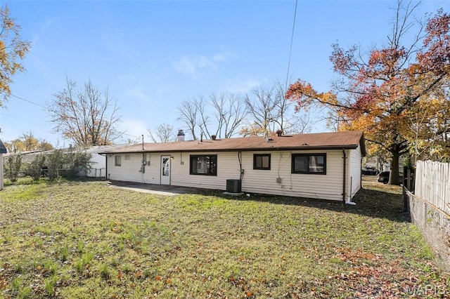 1235 Flicker Dr, Florissant, MO 63031 - rear view of house featuring a fenced backyard, a chimney, and a patio area