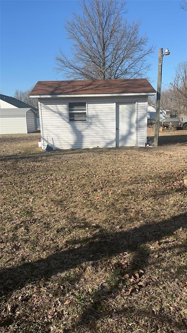 810 E Cedar St, Bertrand, MO 63823 - garage featuring a storage unit