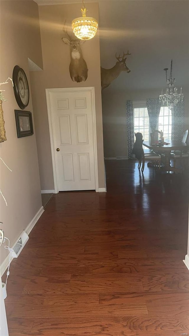 810 E Cedar St, Bertrand, MO 63823 - corridor featuring a chandelier and baseboards