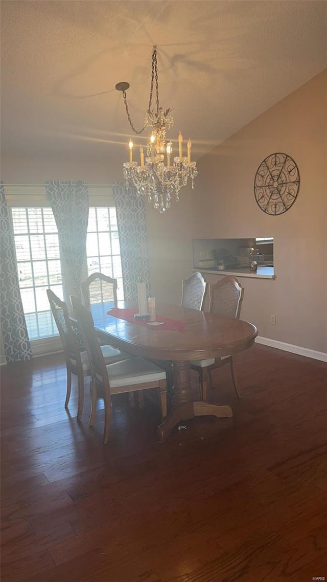 810 E Cedar St, Bertrand, MO 63823 - dining area featuring a chandelier, baseboards, and wood finished floors