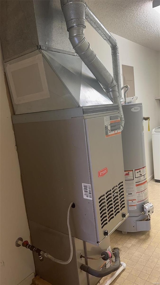 810 E Cedar St, Bertrand, MO 63823 - utilities with water heater, heating unit, and washer / dryer
