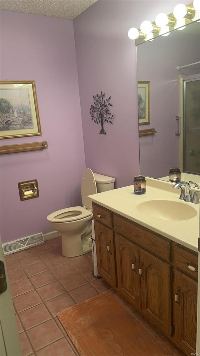 810 E Cedar St, Bertrand, MO 63823 - bathroom featuring tile patterned flooring, toilet, a stall shower, and vanity