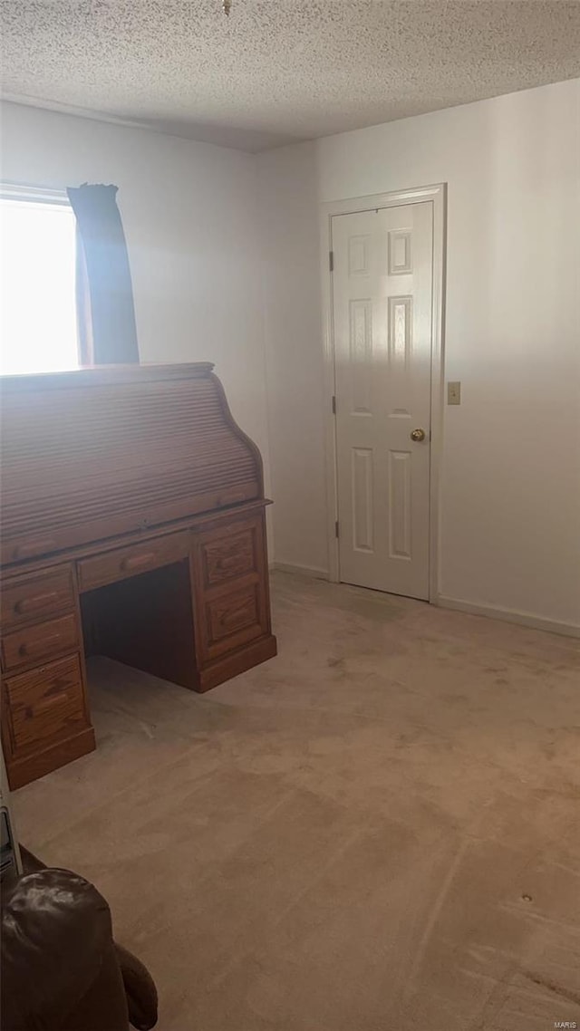 810 E Cedar St, Bertrand, MO 63823 - bedroom with light carpet, a textured ceiling, baseboards, and a desk