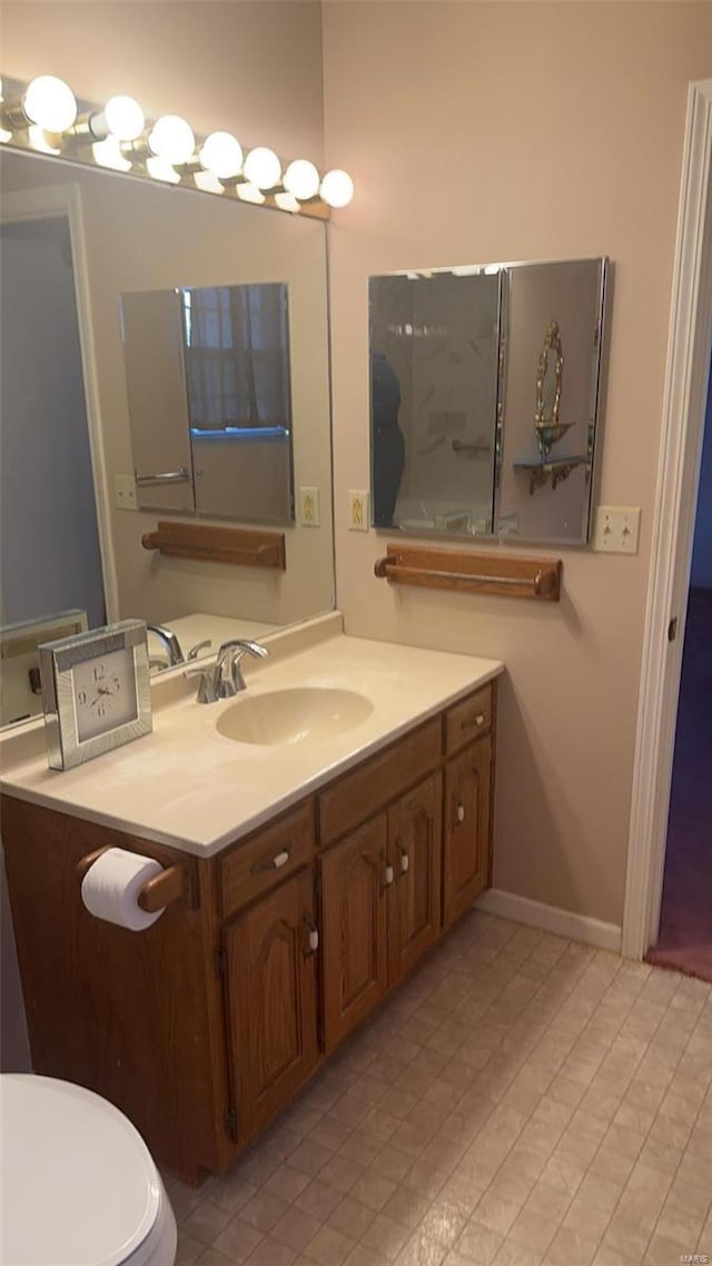 810 E Cedar St, Bertrand, MO 63823 - bathroom featuring vanity, baseboards, toilet, and tile patterned flooring