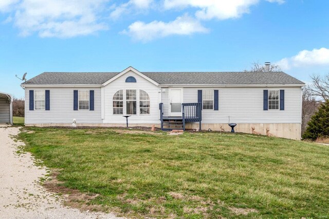 201 Jenna Lee Dr, Foley, MO 63347 - view of front of house with a front yard, a detached carport, a shingled roof, and driveway