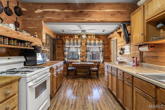 631 Columbia Dr, Bismarck, MO 63624 - kitchen featuring white gas range, wood walls, open shelves, hardwood / wood-style flooring, and light countertops