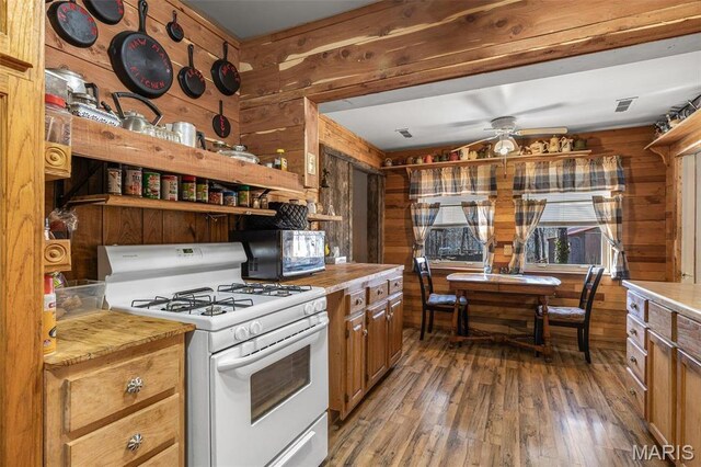 631 Columbia Dr, Bismarck, MO 63624 - kitchen with white range with gas stovetop, wooden walls, a ceiling fan, hardwood / wood-style flooring, and open shelves