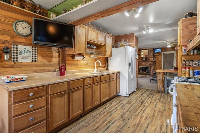 631 Columbia Dr, Bismarck, MO 63624 - kitchen featuring a sink, wood counters, wood walls, white appliances, and ceiling fan