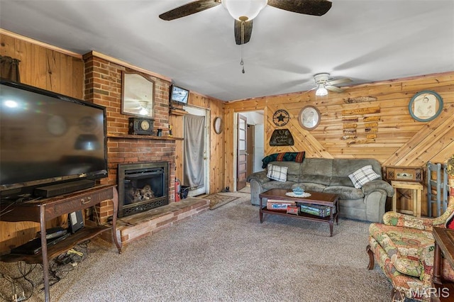 631 Columbia Dr, Bismarck, MO 63624 - carpeted living room with ceiling fan, wood walls, and a fireplace