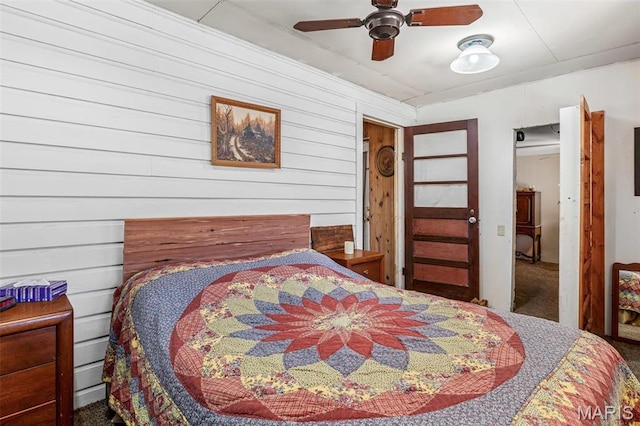 631 Columbia Dr, Bismarck, MO 63624 - bedroom featuring wooden walls, carpet floors, and ceiling fan
