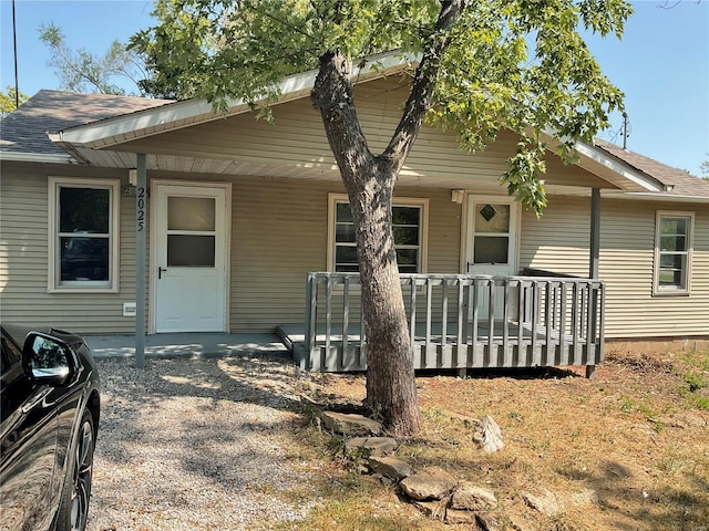 view of front of home with roof with shingles and a porch