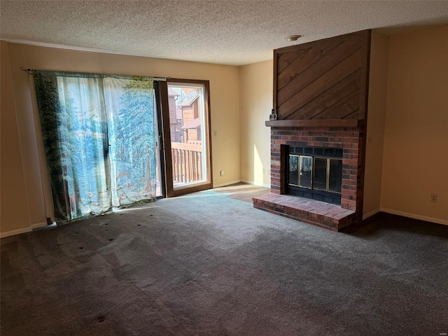 unfurnished living room featuring carpet, a textured ceiling, a brick fireplace, and baseboards