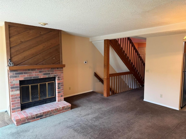 unfurnished living room with carpet flooring, a textured ceiling, a brick fireplace, baseboards, and stairway
