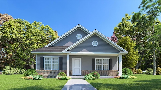 view of front of property with brick siding, a front yard, and covered porch