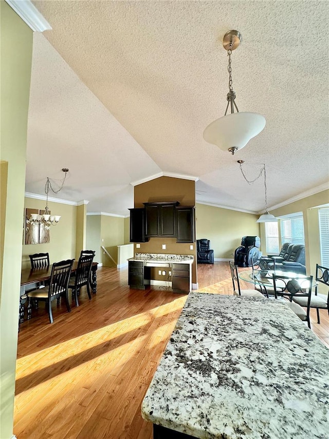 5284 Summer Cir, Imperial, MO 63052 - dining area with ornamental molding, a textured ceiling, a chandelier, light wood finished floors, and lofted ceiling