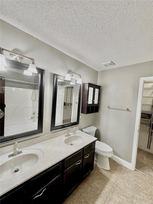 5284 Summer Cir, Imperial, MO 63052 - full bath with a textured ceiling, double vanity, toilet, tile patterned floors, and baseboards
