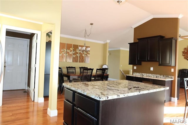 5284 Summer Cir, Imperial, MO 63052 - kitchen featuring light wood finished floors, a chandelier, baseboards, decorative light fixtures, and light stone countertops