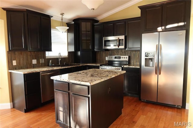 5284 Summer Cir, Imperial, MO 63052 - kitchen featuring stainless steel appliances, a sink, crown molding, light wood-type flooring, and light stone counters