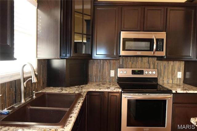 5284 Summer Cir, Imperial, MO 63052 - kitchen with stainless steel appliances, a sink, dark brown cabinets, and decorative backsplash