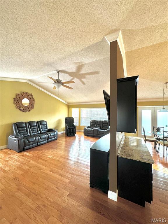 5284 Summer Cir, Imperial, MO 63052 - living area with a textured ceiling, crown molding, ceiling fan, vaulted ceiling, and wood finished floors