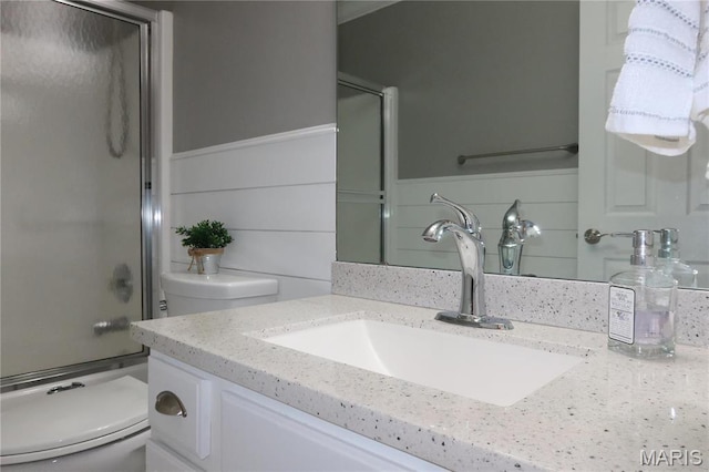 5284 Summer Cir, Imperial, MO 63052 - bathroom featuring toilet, vanity, combined bath / shower with glass door, and wainscoting