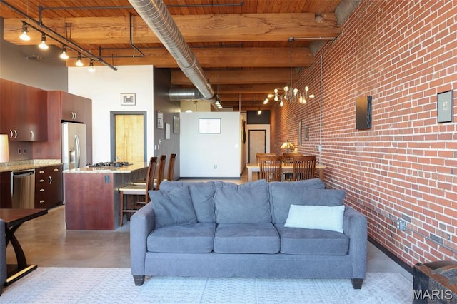 1015 Washington Ave Unit 609, Saint Louis, MO 63101 - living room with brick wall, wooden ceiling, beam ceiling, and finished concrete floors