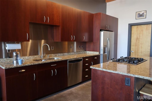 1015 Washington Ave Unit 609, Saint Louis, MO 63101 - kitchen featuring stainless steel appliances, a sink, light stone counters, and a kitchen bar