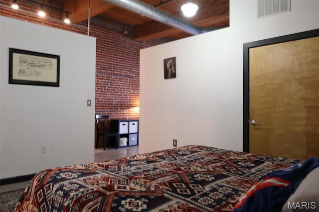 1015 Washington Ave Unit 609, Saint Louis, MO 63101 - bedroom featuring brick wall and rail lighting