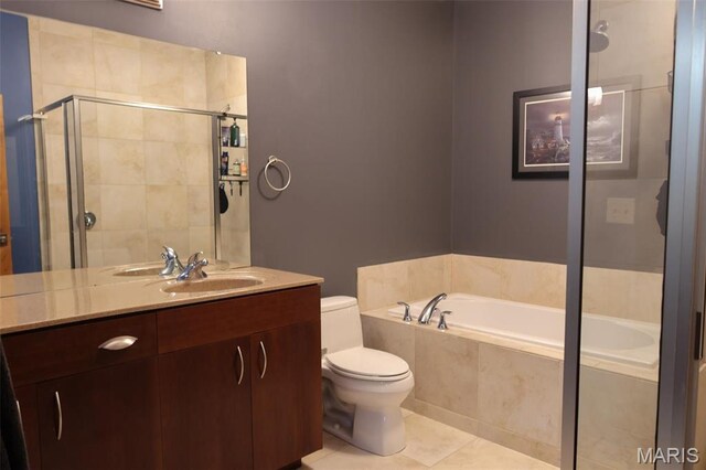 1015 Washington Ave Unit 609, Saint Louis, MO 63101 - full bathroom featuring a garden tub, a stall shower, vanity, toilet, and tile patterned flooring
