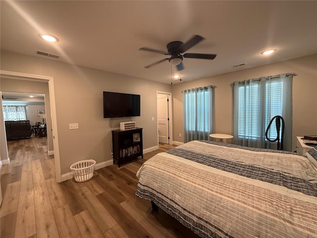 bedroom featuring baseboards, wood finished floors, a ceiling fan, and recessed lighting