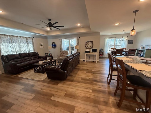 379 Lakeview Cpe, Girardeau, MO 63701 - living room featuring hardwood / wood-style floors, a ceiling fan, a tray ceiling, recessed lighting, and a chandelier